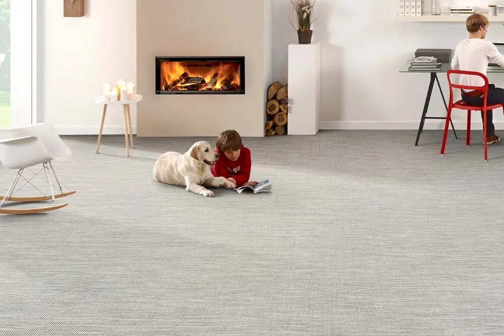 Custom rug Sisal in beige across a living room with fireplace