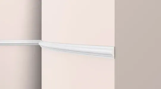 Plain concave cornice moulding, white profile against a terracotta wall