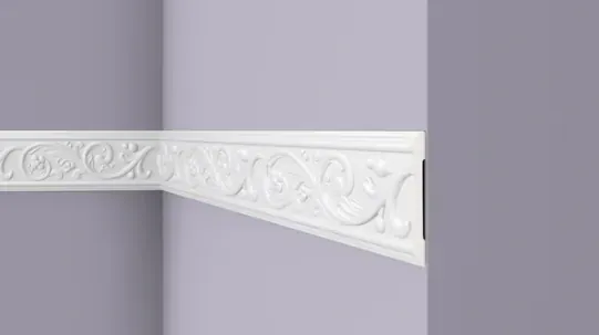 Cornice moulding with carved floral frieze at a mitred corner