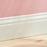 Low skirting board with rounded top edge and cable clip