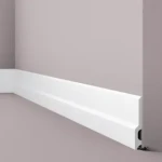 Skirting board with continuous rounded profile in matt light grey