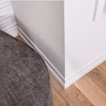 Skirting board with continuous rounded profile in matt light grey