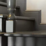Tall flat skirting board in deep grey with visible fixing clip