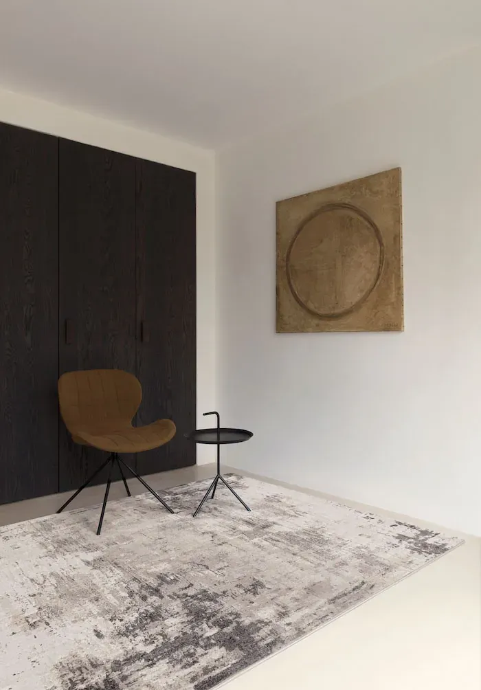 Rug Peat beside a dark wood wardrobe and ochre armchair