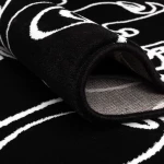 Rug Soft Ash with white line-drawn faces on black