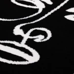 Rug Soft Ash with white line-drawn faces on black