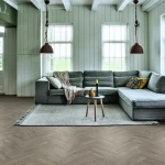 Vinyl flooring Copper, light wood planks in a chevron pattern
