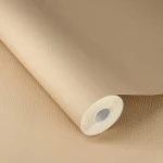 Wallpaper Peat in plain beige with a fine leather grain