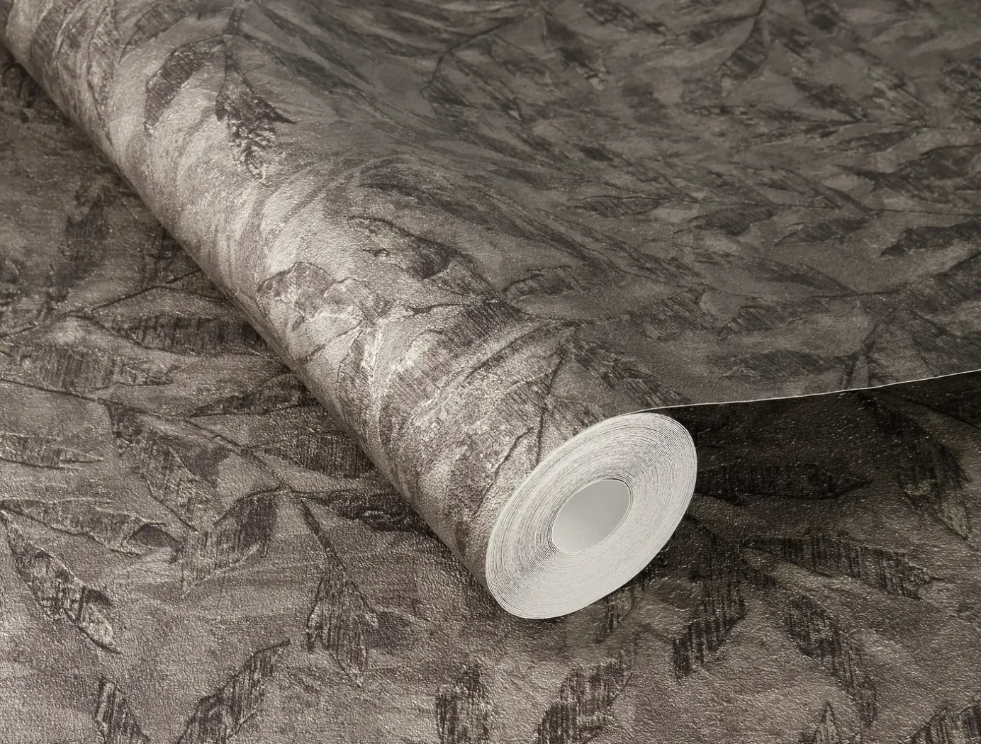 Wallpaper Deep Stone with dark leaf silhouettes on anthracite