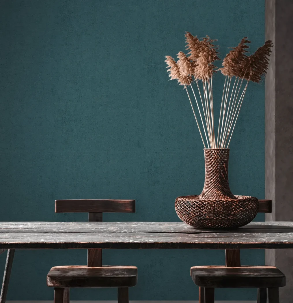 Wallpaper Deep Lapis in plain petrol blue behind a wooden table