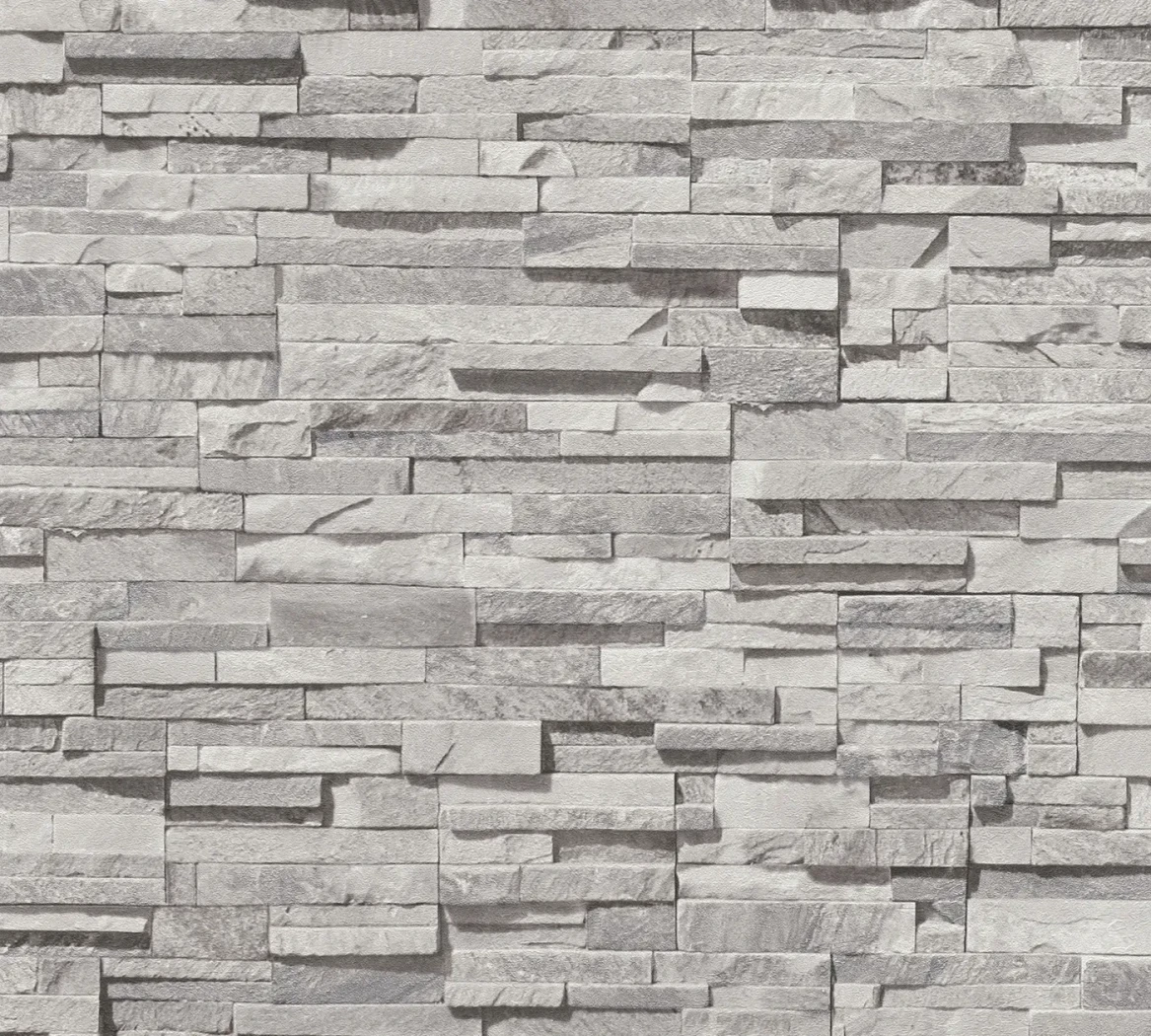 Wallpaper Soft Anthracite, grey stacked-stone effect on a wall