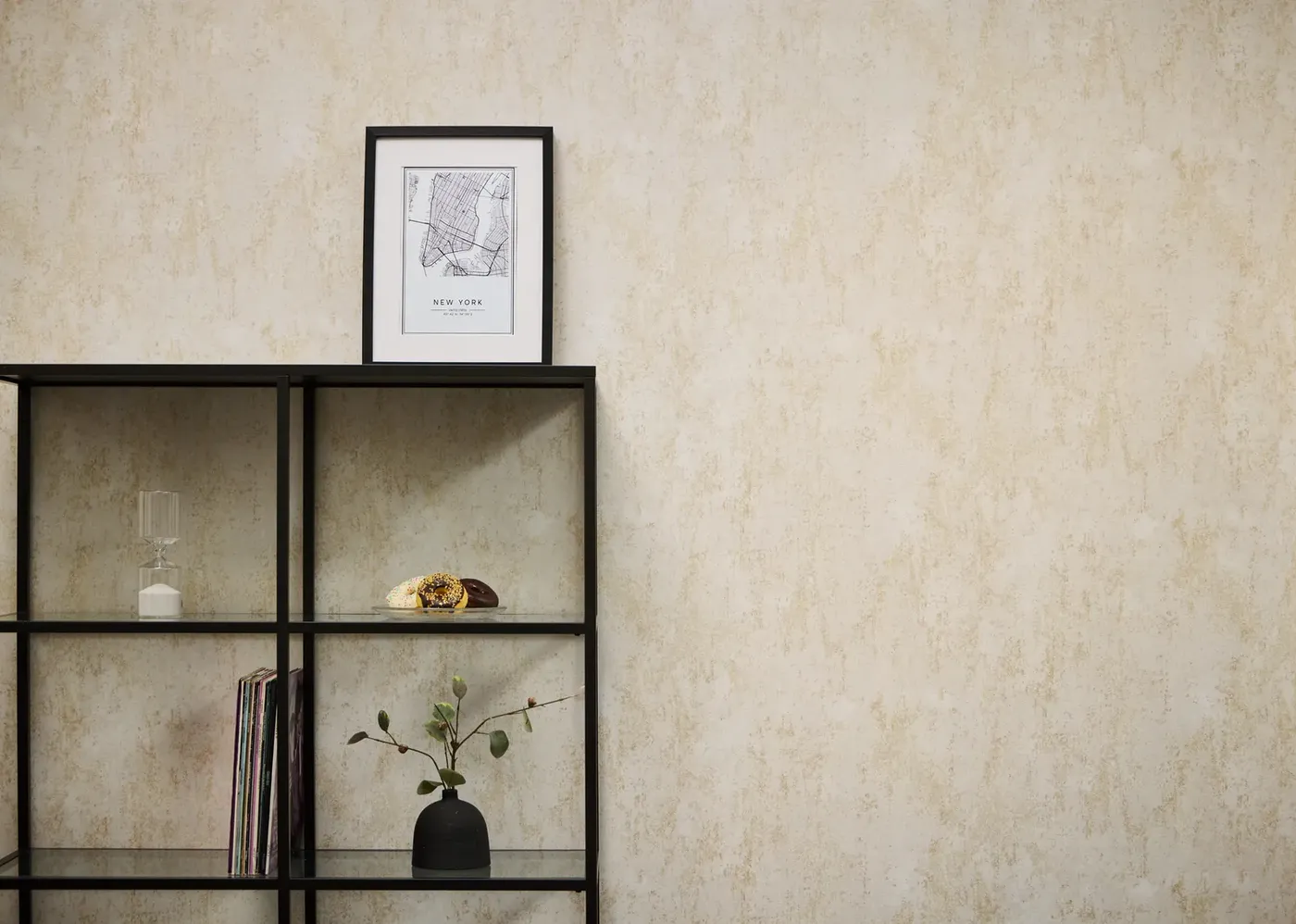Wallpaper Misty Tobacco, cream plaster effect behind a black metal shelf